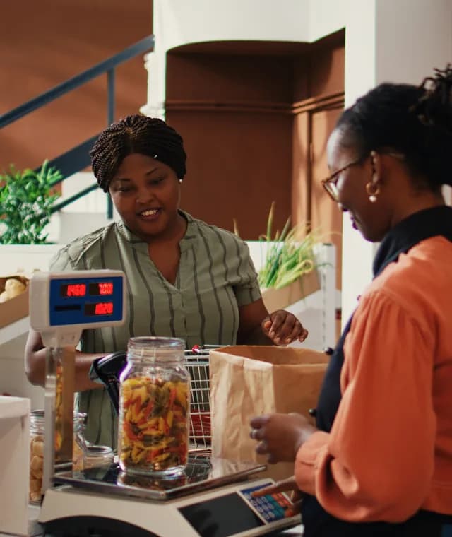 Cashier serving a customer at a store checkout