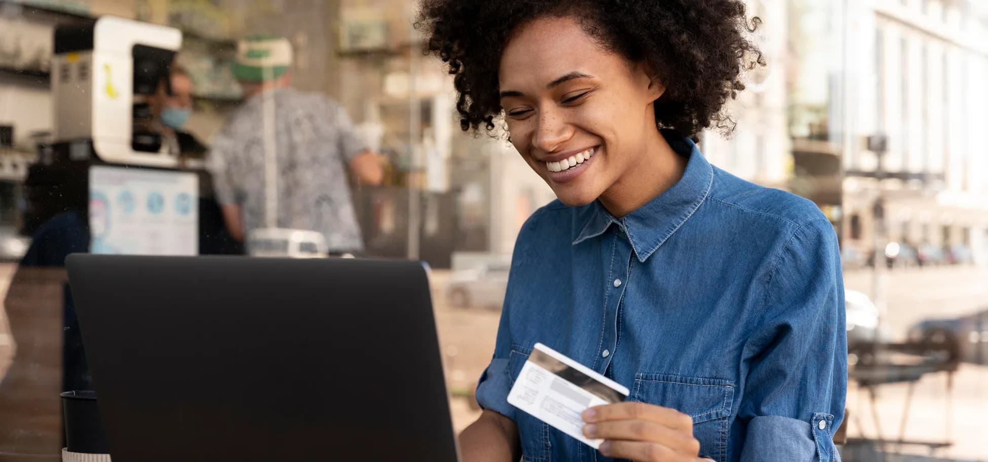 Smiling customer paying online with a bank card